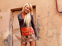 A cute blonde teen in a plaid skirt with pink panties puts on a little upskirt show for the camera.  Bending over to show her ass and camel toe.